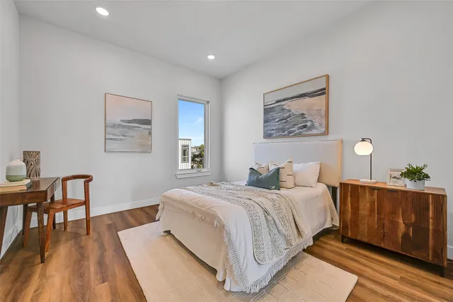 a bedroom with a large bed and a desk