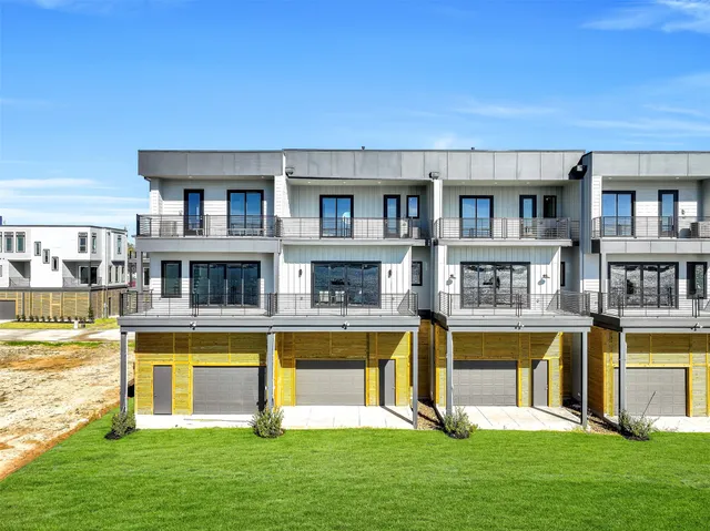 a front view of a house with swimming pool and a big yard