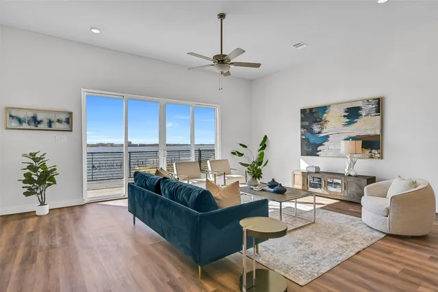 a living room with furniture potted plant and a large window