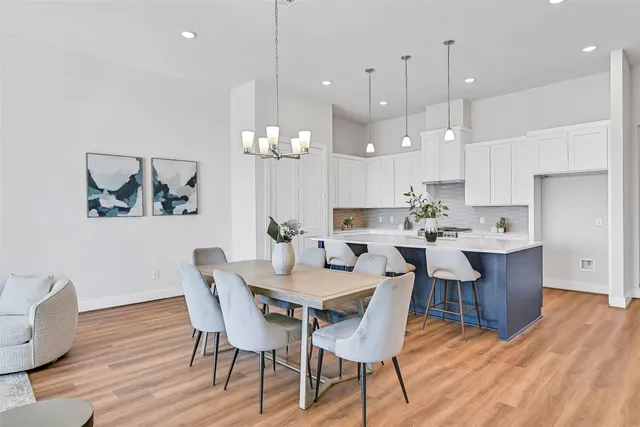 a view of a dining room with furniture wooden floor and chandelier