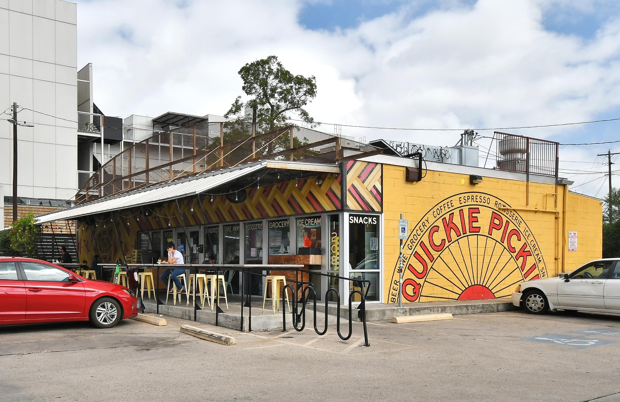 800 Embassy Drive, Unit 602 Austin, TX 78702 - Photo 32 of 37 Vibrant commercial facade featuring a yellow exterior with a large sunburst mural
