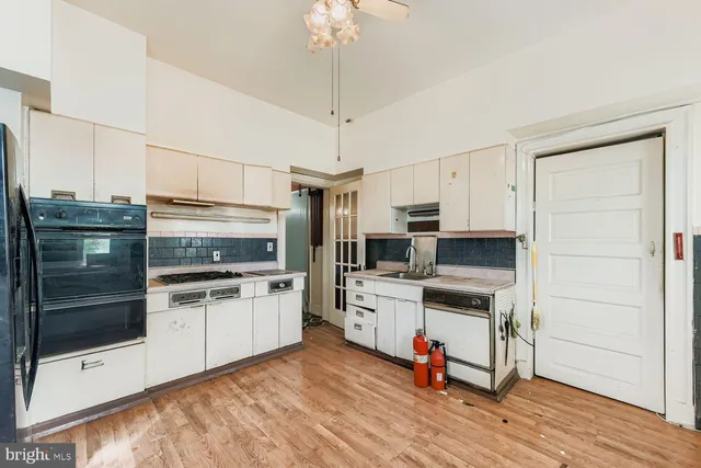 a kitchen with a sink appliances and cabinets