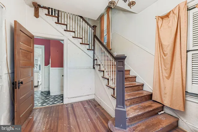 a view of entryway with wooden floor and stairs