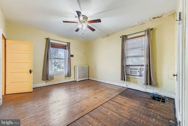 wooden floor in an empty room with a window