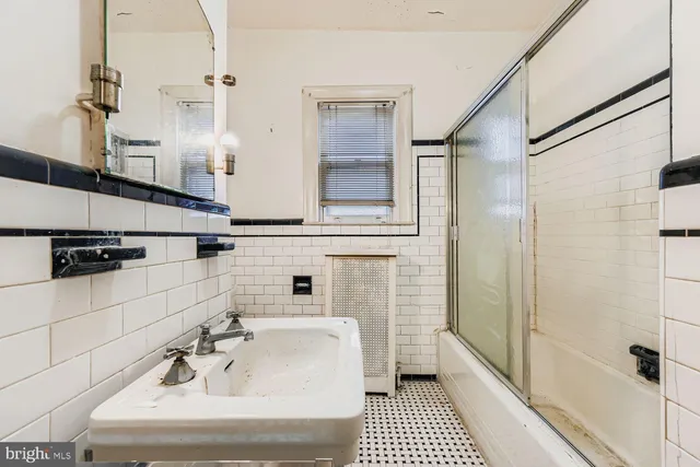 a bathroom with a bathtub and shower