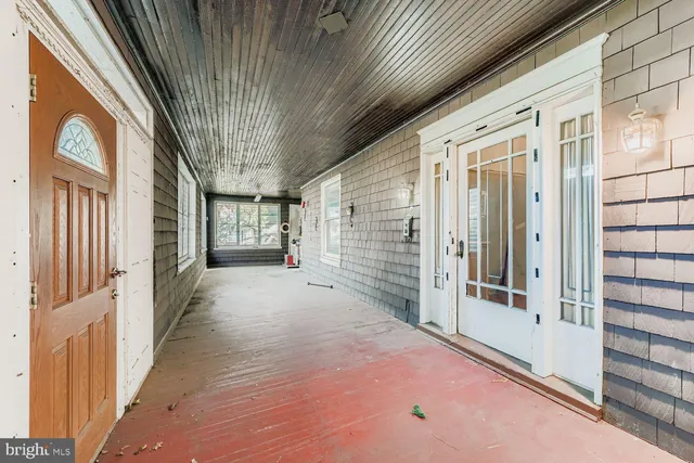 a view of a porch with wooden floor and fence