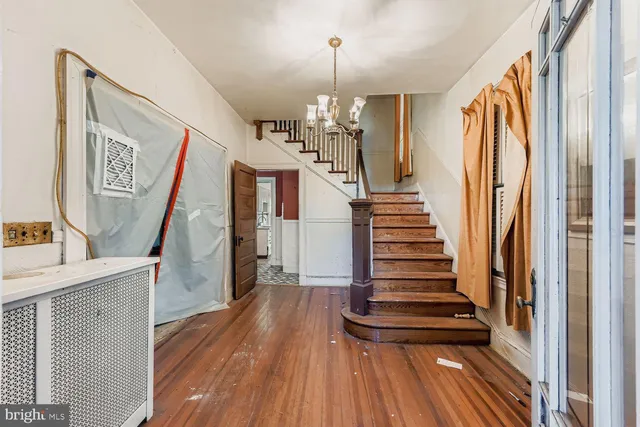 a view of entryway with stairs and wooden floor