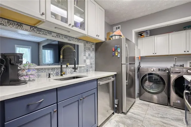 a utility room with cabinets dryer and washer