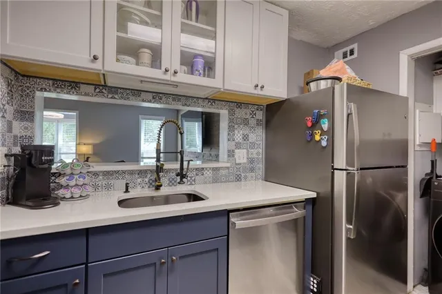a kitchen with stainless steel appliances a sink and cabinets