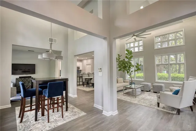 a living room with furniture dining table and a large window