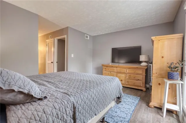 a bedroom with a bed and flat screen tv