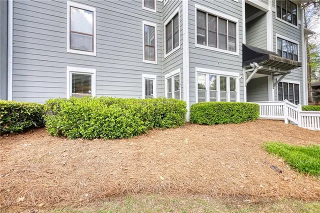 a view of a brick building next to a yard