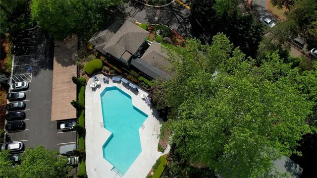 an aerial view of a house with a yard and large trees
