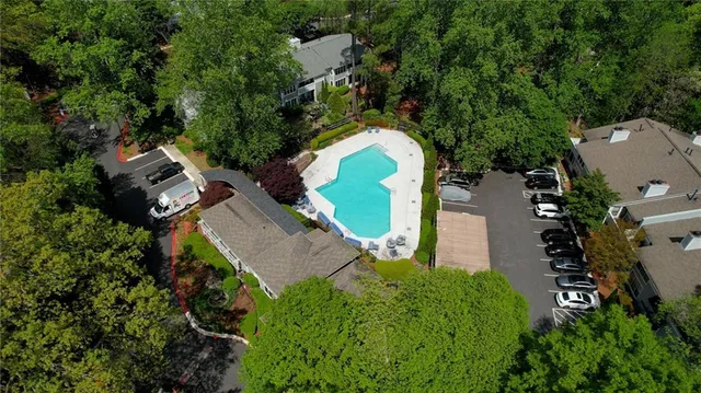 an aerial view of a house with a yard and swimming pool