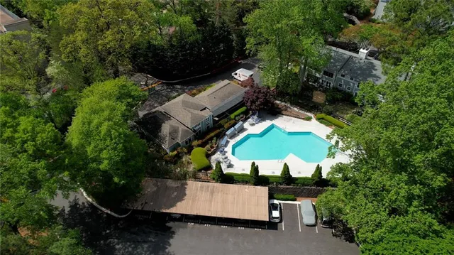 an aerial view of a house with a yard and swimming pool