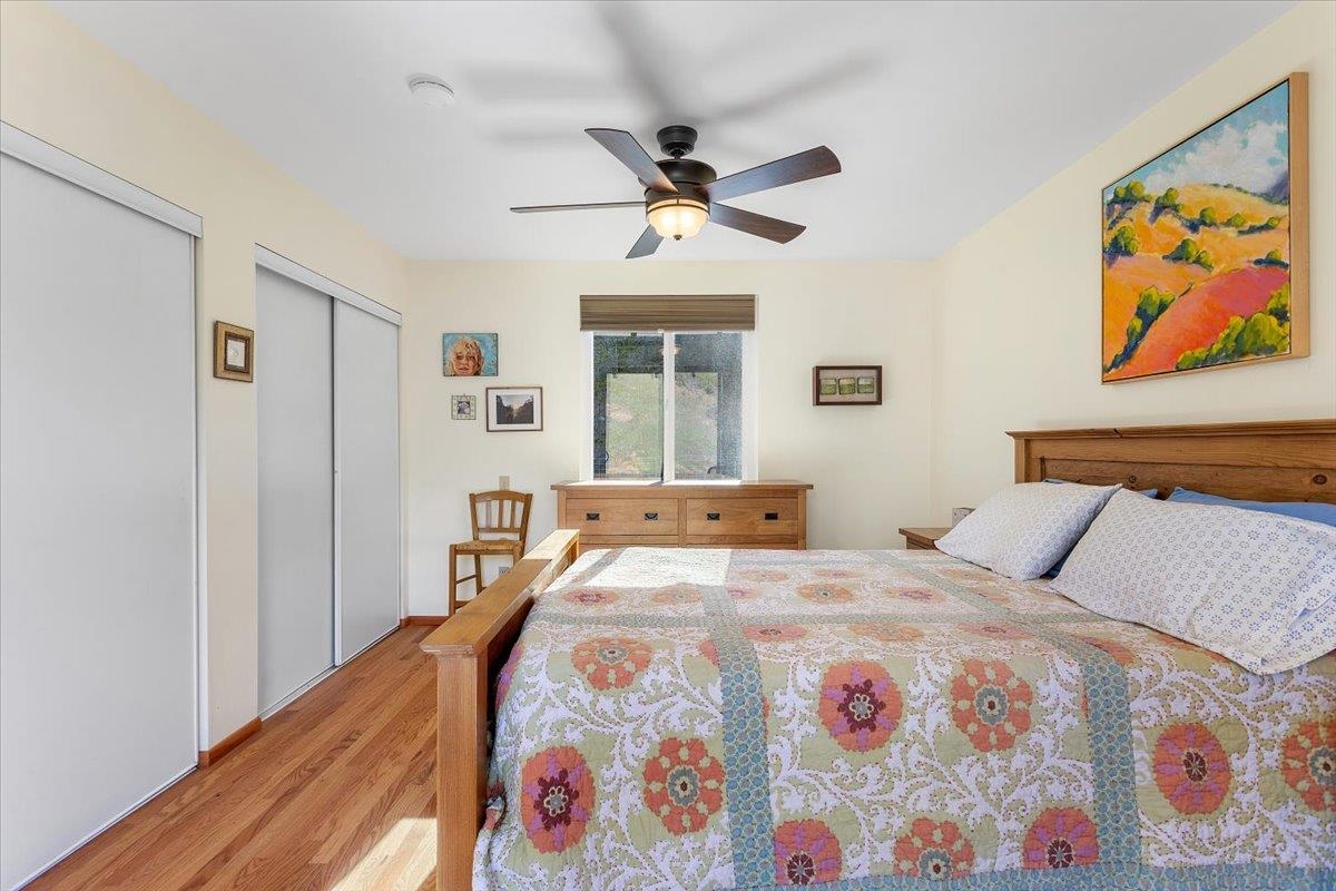 17370 Mines Road Livermore, CA 94550 - Photo 14 of 43 a bedroom with a bed and a chandelier