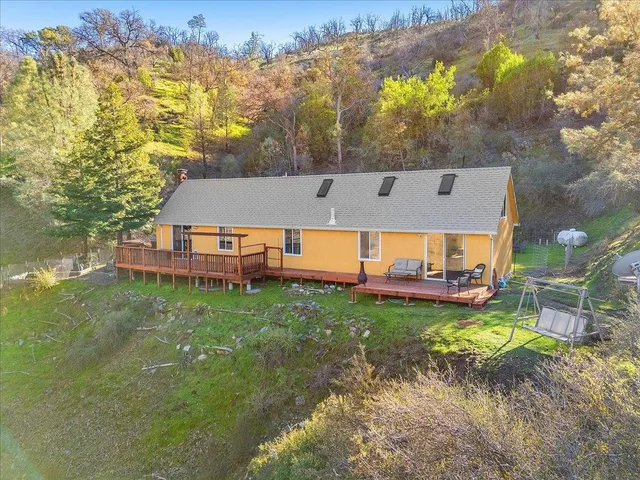 a view of a house with a yard balcony and sitting area