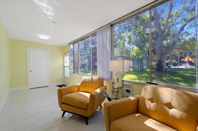 a living room with furniture and a large window