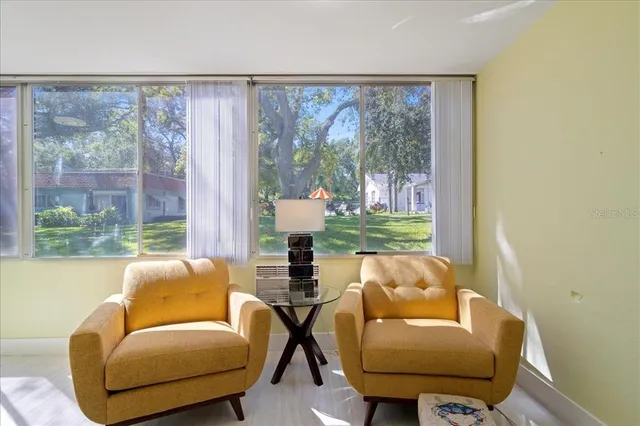 a living room with furniture and a large window