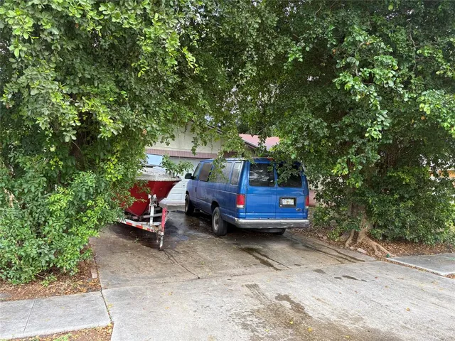 a view of yard with seating area and trees around