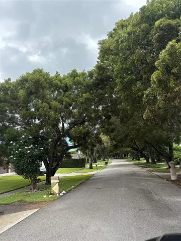 a view of a street with houses on both side