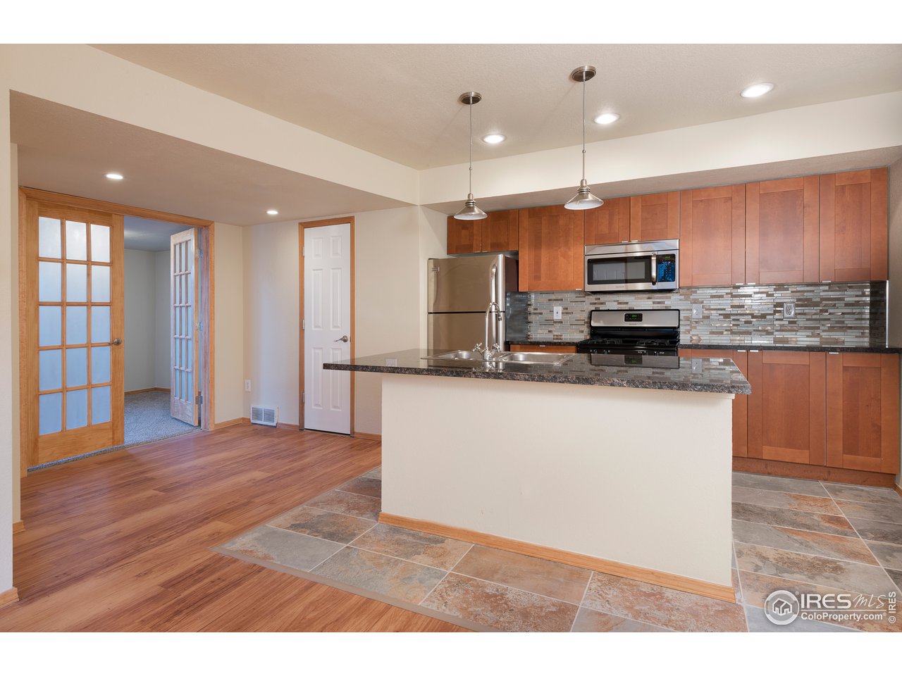 2535 Spruce Street Boulder, CO 80302 - Photo 12 of 17 a kitchen with stainless steel appliances granite countertop a refrigerator a stove a sink and a microwave