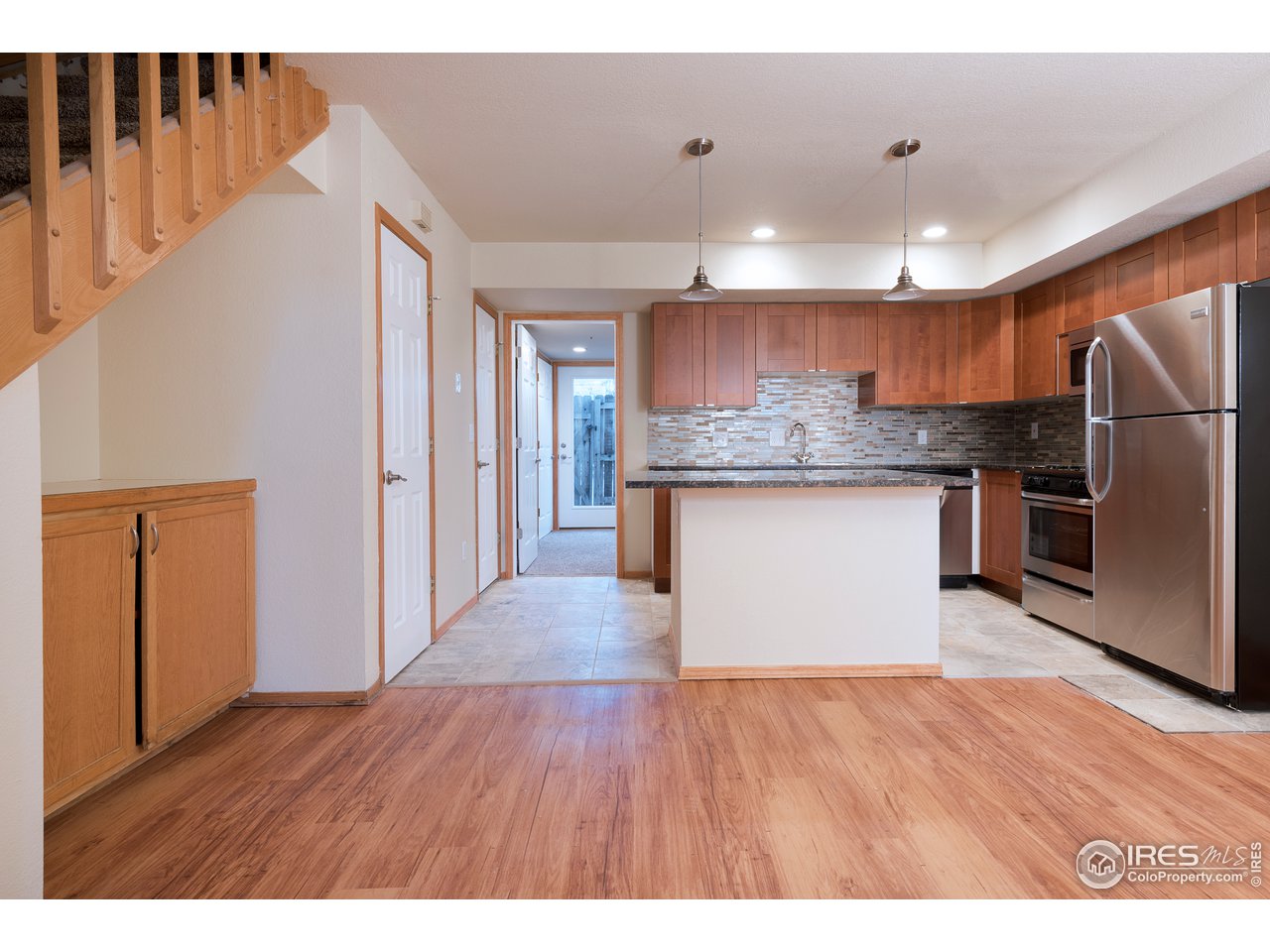 2535 Spruce Street Boulder, CO 80302 - Photo 15 of 17 a kitchen with stainless steel appliances granite countertop a refrigerator a sink dishwasher a stove and a wooden floor