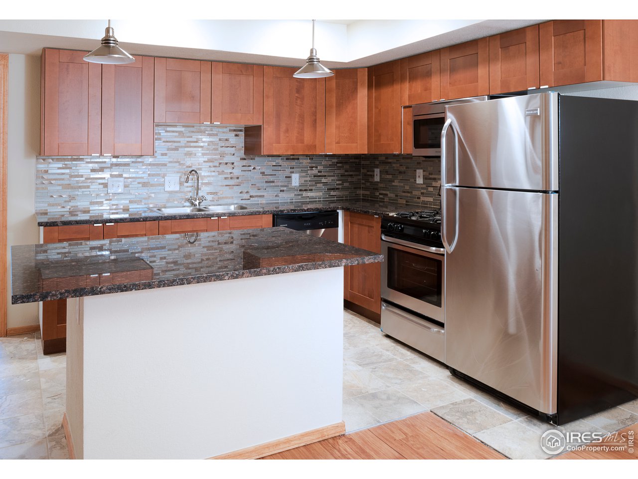 2535 Spruce Street Boulder, CO 80302 - Photo 16 of 17 a kitchen with stainless steel appliances granite countertop a refrigerator a stove and a sink