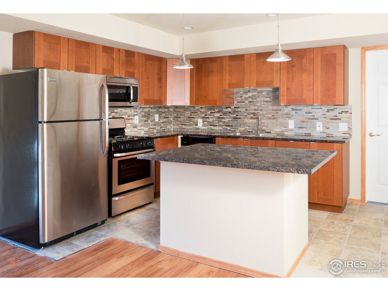 2535 Spruce Street Boulder, CO 80302 - Photo 8 of 17 a kitchen with stainless steel appliances granite countertop a refrigerator a sink and a stove