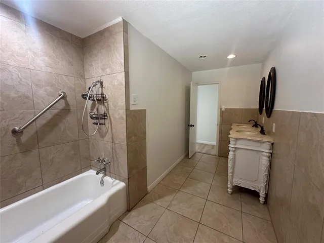 a bathroom with a bathtub and a sink