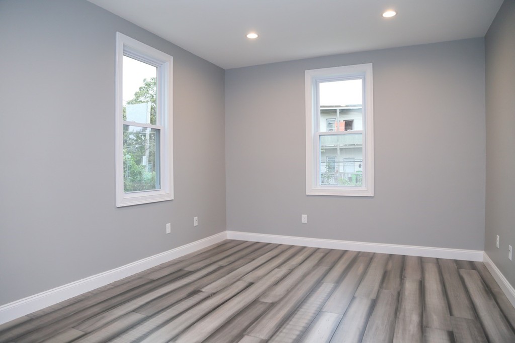 56 Byron Street, Unit 2 Boston, MA 02128 - Photo 11 of 17 wooden floor in an empty room with a window