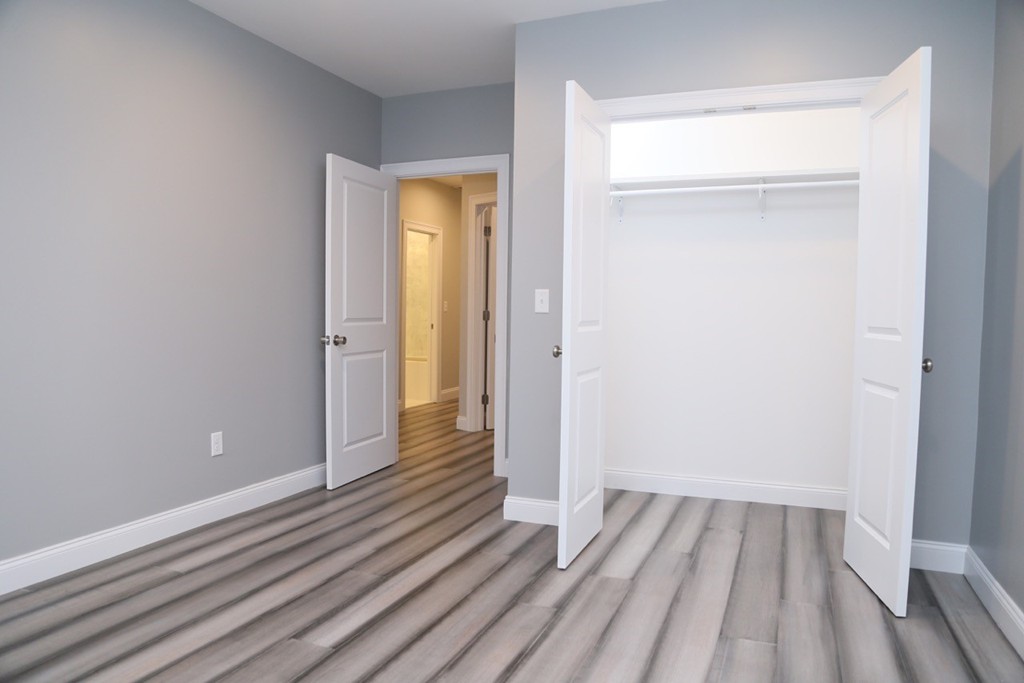 56 Byron Street, Unit 2 Boston, MA 02128 - Photo 12 of 17 a view of a room with wooden floor and a bathroom