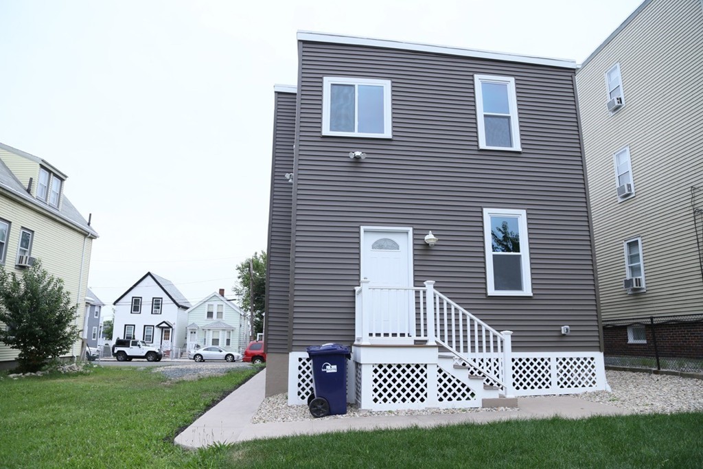 56 Byron Street, Unit 2 Boston, MA 02128 - Photo 16 of 17 a front view of a house with a yard