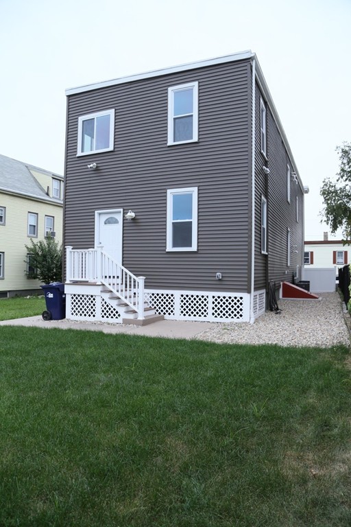 56 Byron Street, Unit 2 Boston, MA 02128 - Photo 17 of 17 a front view of a house with a garden and yard