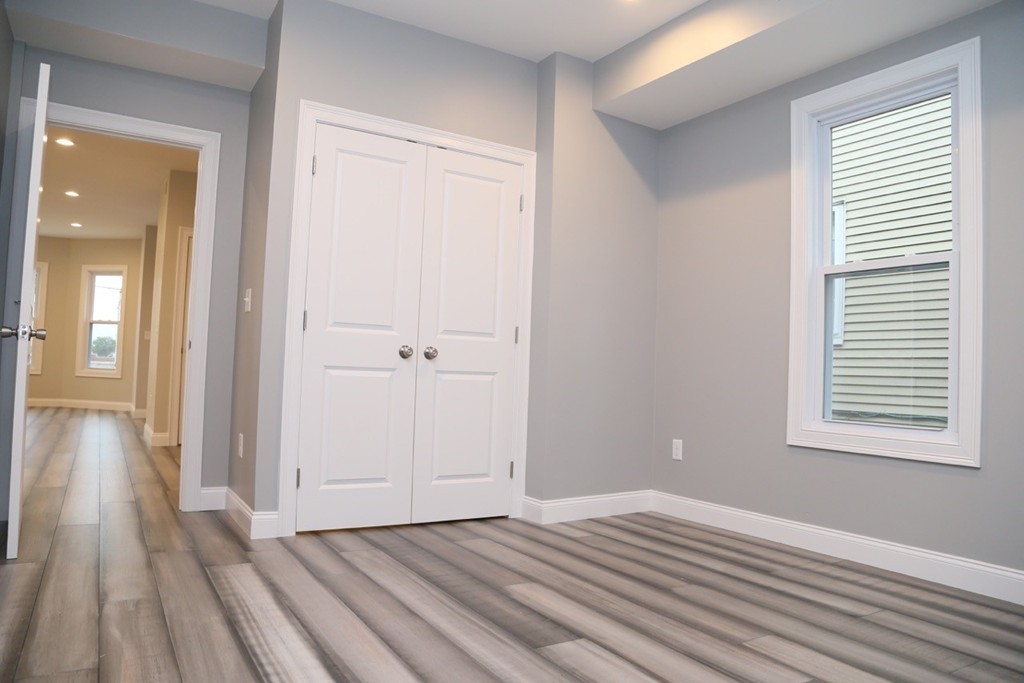 56 Byron Street, Unit 2 Boston, MA 02128 - Photo 10 of 17 a view of a room with wooden floor and a bathroom