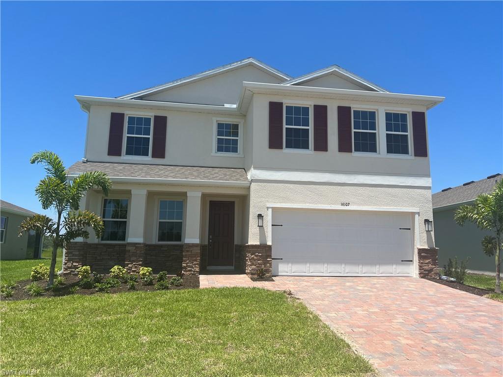28190 Captiva Shell Loop Bonita Springs, FL 34135 - Photo 1 of 20 a front view of a house with a yard and garage