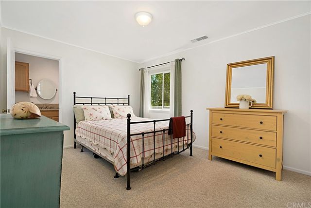 a bedroom with a bed and a dresser