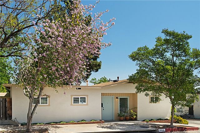 a front view of a house with trees
