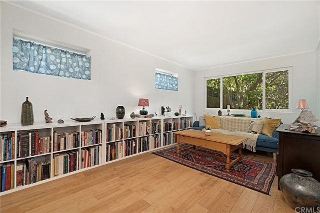 a living room with furniture a rug and a large window