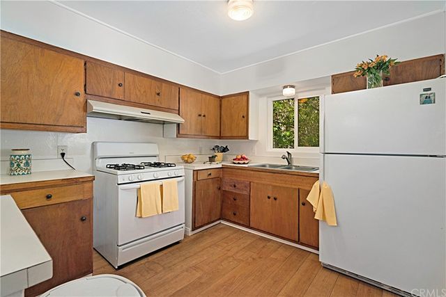 a kitchen with a sink a stove a refrigerator and a refrigerator