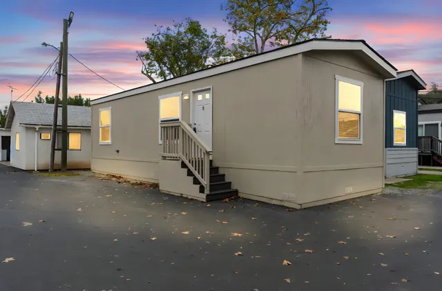 a white house with a large tree