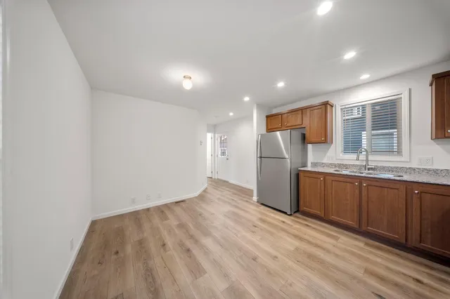 a kitchen with stainless steel appliances granite countertop a refrigerator sink and cabinets