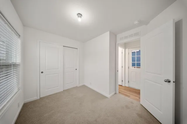 a view of a big room with closet and windows