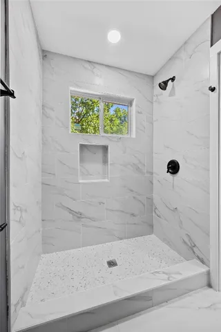 a bathroom with a shower and a bathtub