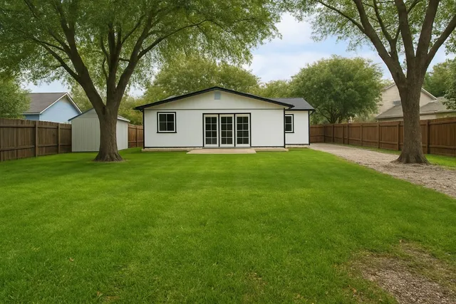a yellow house in middle of the forest