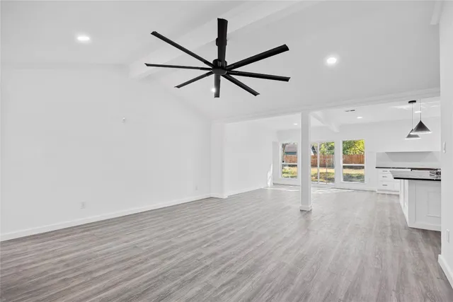a view of a livingroom with wooden floor and a ceiling fan