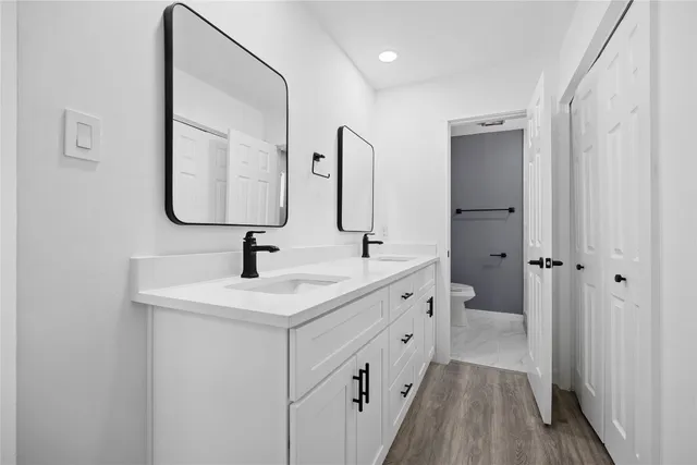 a bathroom with 2 sink and a mirror