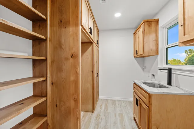 a view of walk in closet with empty racks