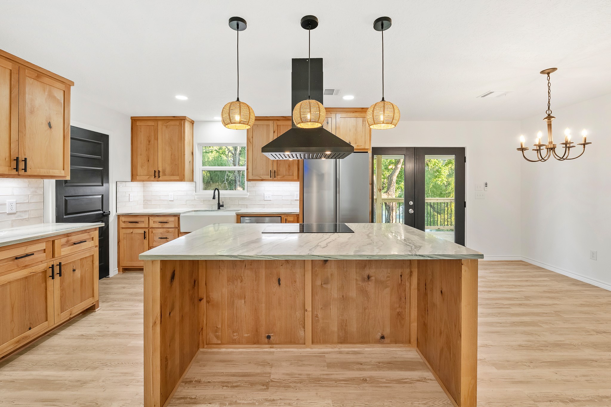 90 Cool Crest Point Blank, TX 77364 - Photo 3 of 40 a kitchen with kitchen island granite countertop wooden floor and a chandelier