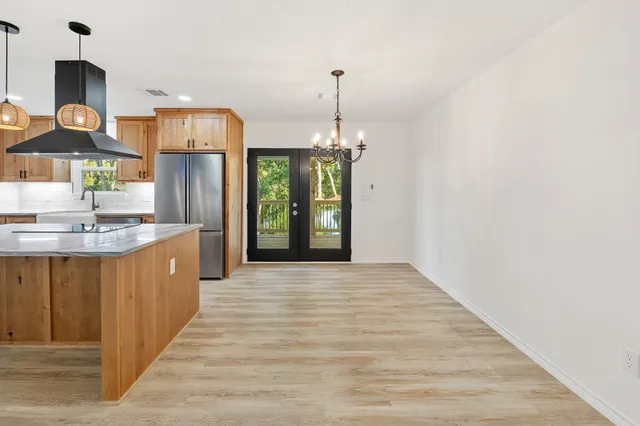 a kitchen with stainless steel appliances granite countertop a stove a sink and a refrigerator